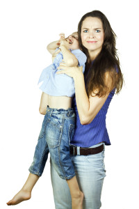 Young Mother Holding A Screaming Child