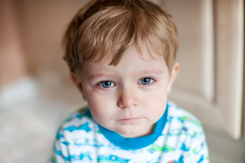 Crying toddler boy with blue eyes and blond hairs